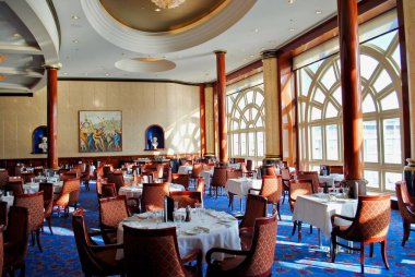Mediterranean Sea: Norwegian Cruise Line (NCL) Spirit Cruise Ship interior Windows main dining room is set for dinner service. No passengers. Empty cruise ship.
