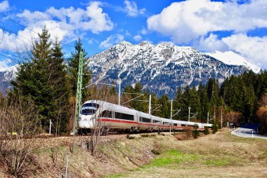Oberammergau, Germany: A Deutche Bahn German train runs through the alps in Bavaria. 