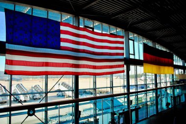 Ramstein, Almanya: Ramstein Hava Üssü PAX yolcu terminali. Alman ve Amerikan bayrakları Almanya 'da yaşayan Kaiserslautern Askeri Cemaati' nin ana kapısında asılı..