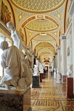 ST PETERSBURG, RUSSIA: Hermitage Museum - Gallery of the History of Ancient Paintings. White Greek and Roman neo-classical marble statues line the center. 80 paintings imitate ancient paintings clipart