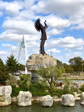 Wichita, Kansas: The Keeper of the Plains is a 44-foot, 5-ton weathered steel sculpture by Kiowa-Comanche artist Blackbear Bosin at the confluence of the Arkansas and Little Arkansas rivers. clipart