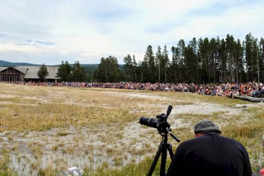 Yellowstone National Park, Wyoming, USA: Crowds of tourists gather to watch Old Faithful Geyser. It is a highly predictable geothermal feature that makes it a popular tourist attraction. clipart
