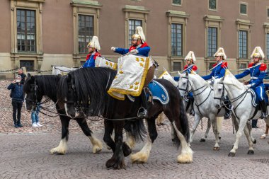 STOCKHOLM, SWEDEN - 30 Nisan 2018: 72 yaşındaki Kral XVI Gustaf 'ın Stockholm' deki Kraliyet Sarayı 'nda kutlaması. İsveç Kraliyet Süvari Birliği (Livgardets Dragonmusikkr). Turistler tören alayının fotoğraflarını çekiyor.