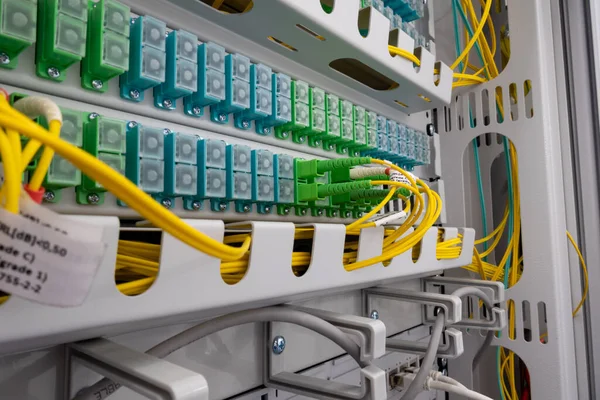 Patch panel of fiber optic network cables. Fiber optic installation in a rack