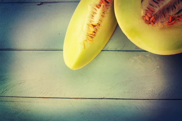 Soczysty melon miód spadziowy na tle drewniany stół. — Zdjęcie stockowe
