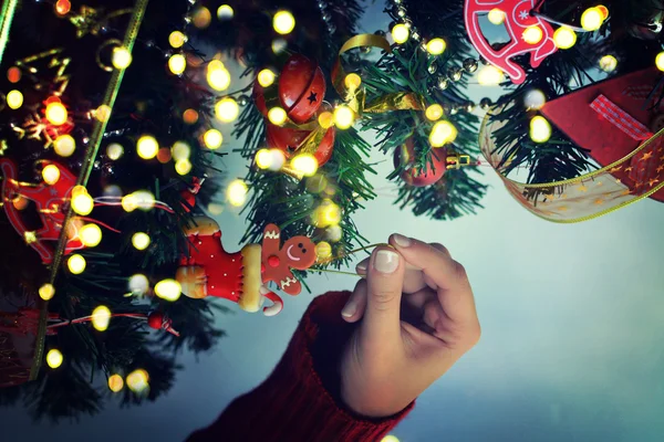 Decorating Christmas tree on bright background — Stock Photo, Image