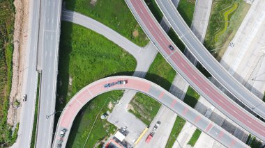 Aerial view of highway and overpass in city on a sunny day. 
