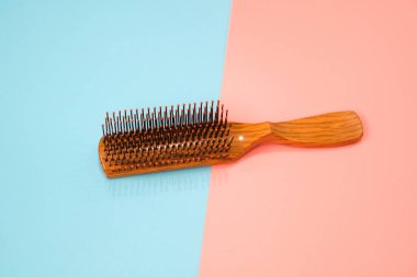 Comb on pink and blue background.
