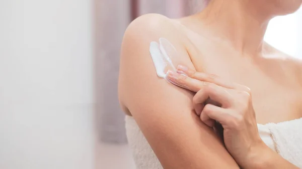 Woman applying natural cream, Woman moisturizing her arm with cosmetic cream, Spa and Manicure concept.