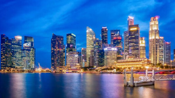 Singapore, Singapore - August 11, 2014. A view of the Marina Bay waterfront and downtown central business district skyline at dusk.