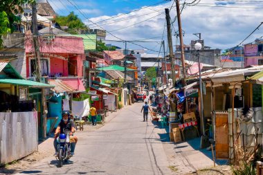 Sabang Village, Puerto Galera, Philippines - May 4, 2021: View of the uncrowded market street in a small resort community located on Mindoro Island. clipart