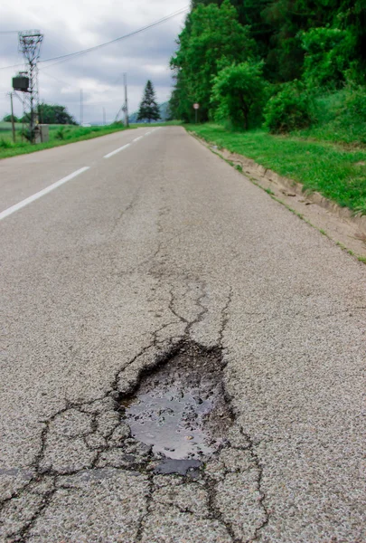 Damaged asphalt road — Stock Photo, Image