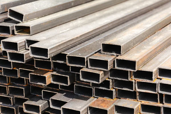 metal rectangular profile in a stack, metal pipes of rectangular cross-section on the site of a building materials store, metal building materials.