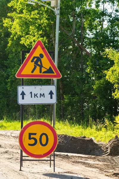 sign road works and speed limit on dangerous road section, road repair, danger, road construction.