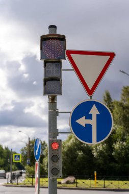 Şehir kavşağında trafik ışıkları ve yol işaretleri. Sinyalin değişmesine saniyeler kaldı..