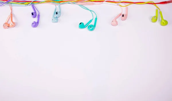 Multi Colored Earphones Hanging Cables Party Props White Background Music — Stock Photo, Image