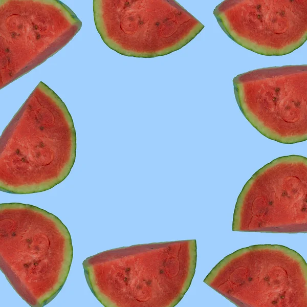 Trendy pink background with sliced juicy watermelon. Minimal summer concept. With copy space.