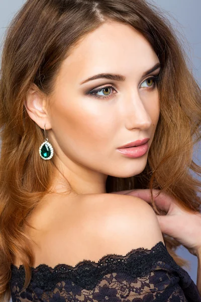 Girl in black lace dress with earring — Stock Photo, Image