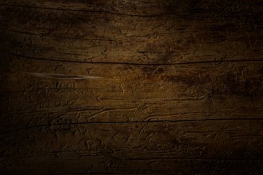 Koyu renk ahşap, ince çatlaklar ve çizik desenleri var. Tasarım çevresi kavramı için yakın plan.