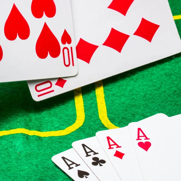combination of four aces and falling playing cards on the field for playing poker a bright green canvas concept of gambling and casino