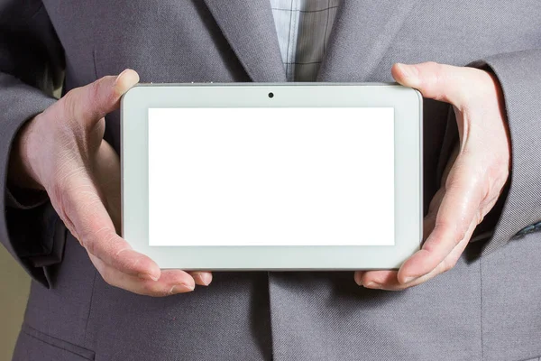 gray tablet with a white screen in the hands of a man dressed in a gray jacket closeup business and technology concept