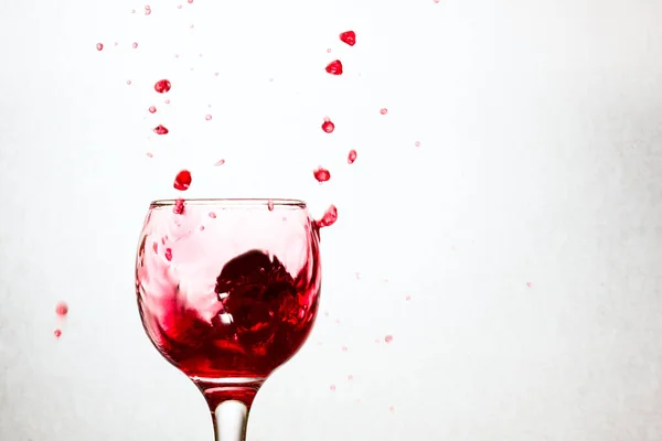 Lot Bright Drops Red Wine Flying Out Glass Gray Background — Stock Photo, Image