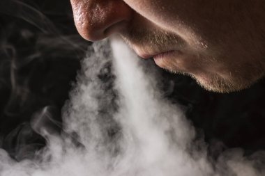 Sigara dumanı bulutu. Sigara içmenin ve kötü alışkanlıkların kokusunu soluyor.