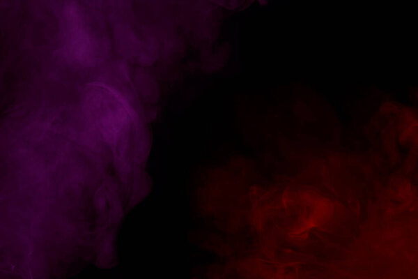 Red and purple mysterious clouds of cigarette vapor bewitching patterns on a dark background