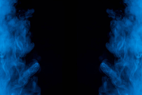 Symmetrical two clouds of blue cigarette vapor on a dark background exciting patterns background for design