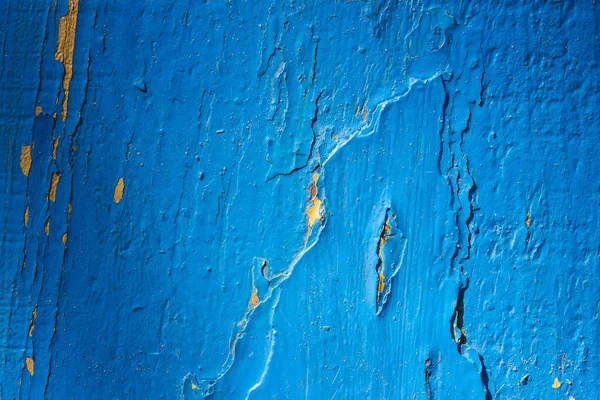 Kısmen soyulmuş mavi boyalı ahşap dokusu yakın plan ve dizayn için koyu kenarlı grunge arkaplanı