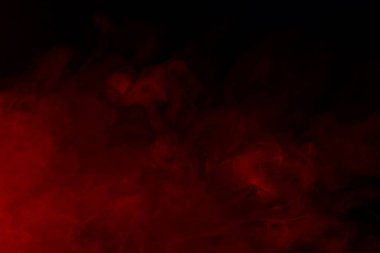 Karanlık bir arka planda sihirli kırmızı sigara buharı ve tasarım sigara içme kavramı için gizemli bir arka plan.