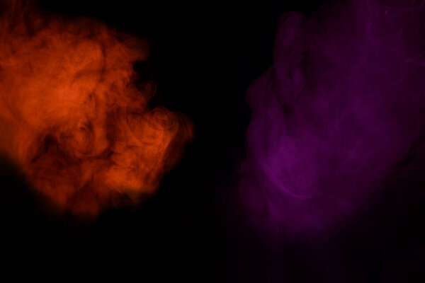 Fiery orange and otherworldly purple clouds of cigarette vapor on a dark background concept of smoking and Halloween abstraction for design