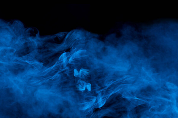 Mystical blue mist bewitching and ghostly cigarette vapor color concept of smoking