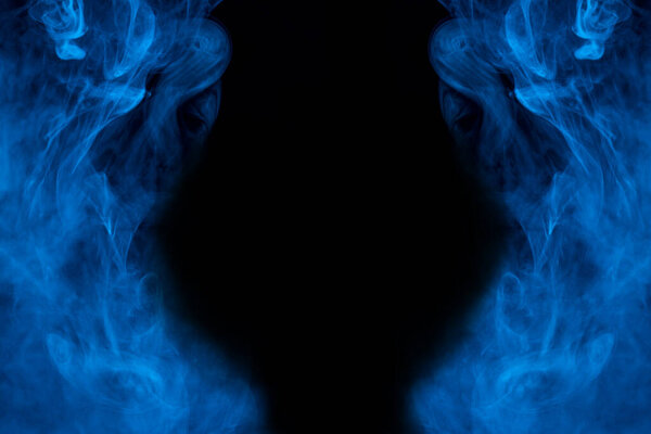 Ghostly clouds of blue vapor around the edges against a dark background bewitching pattern abstraction for design