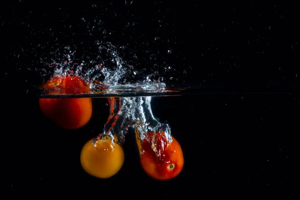 Three Bright Tomatoes Dropped Water Dark Background Beautiful Splashes Water — Stock Photo, Image