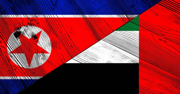 朝鲜和阿拉伯联合酋长国装饰彩旗的木制背景 — 图库照片