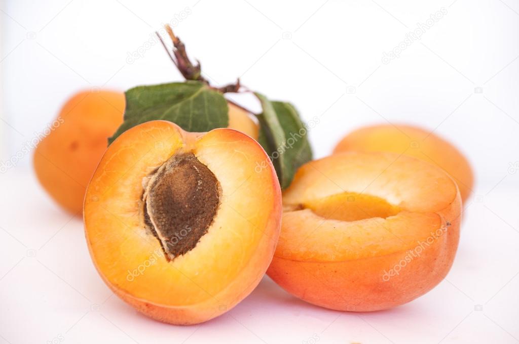ripe apricots on white background