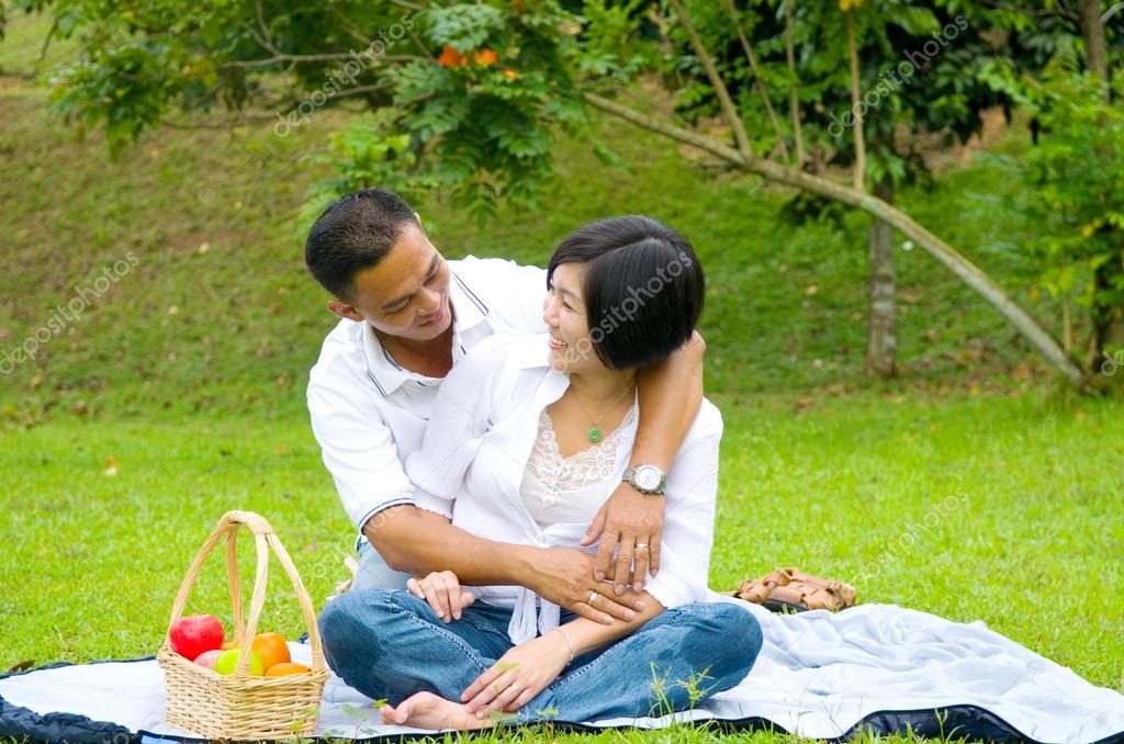 Watching outdoor couple asian