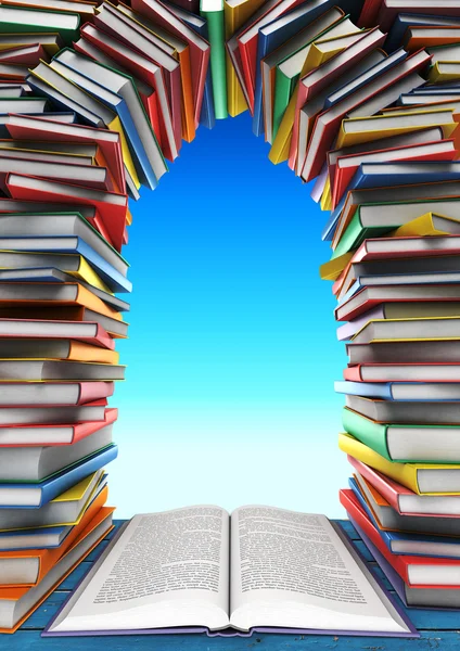 Open book and stack of books in the form of windows, doors, frames in the background of the sky — Stock Photo, Image