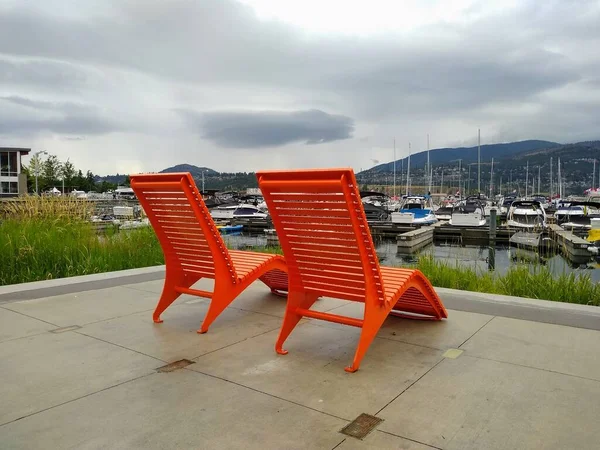 Large Wooden Bright Orange Chairs Lake Yachts Mountains Background — Stock Photo, Image