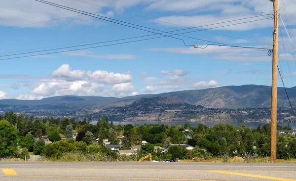 Vista Panorâmica Das Casas Entre Árvores Lago Montanhas Nuvens Fundo — Fotografia de Stock