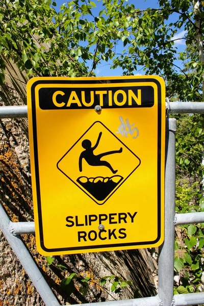 Warning Sign Caution Slippery Rocks Black Letters Picture Slipping Man — Stock Photo, Image