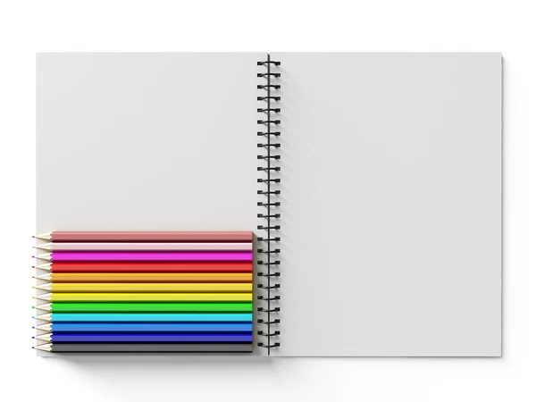 Notebook com lápis de cor sobre fundo branco — Fotografia de Stock