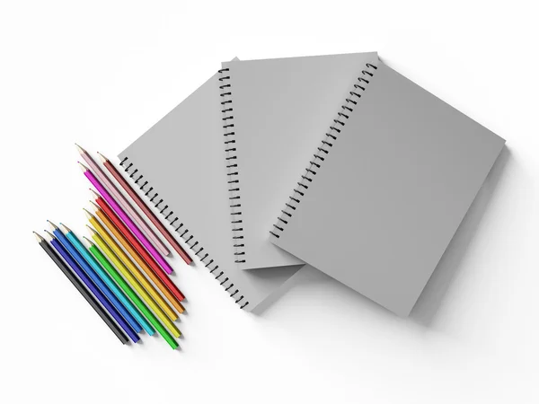 Zápisník s pastelkami na bílém pozadí — Stock fotografie