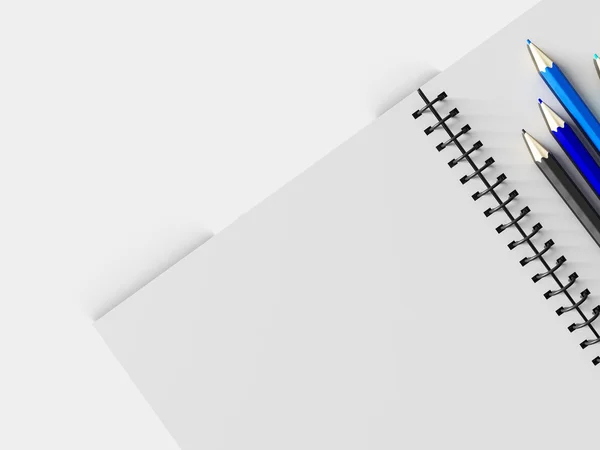 Notebook com lápis de cor sobre fundo branco — Fotografia de Stock