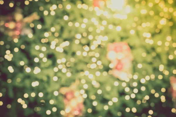 Gold Christmas background of de-focused lights with decorated tr — Stock Photo, Image