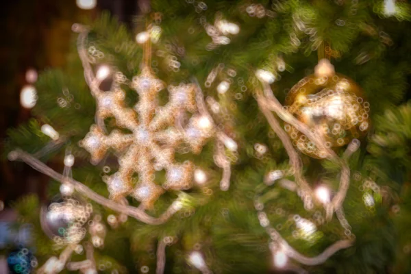 Gold Christmas background of de-focused lights with decorated tr — Stock Photo, Image