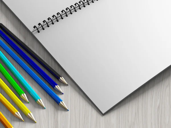 Färg penna på incheckat anteckningsboken på trä bakgrund — Stockfoto
