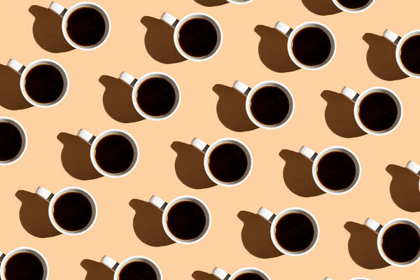 A colorful hard light pattern of a coffee cup on beige surface