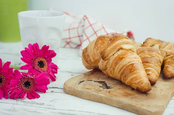 Several Butter Croissant Wooden Board Several Magenta Gerberas White Surface — Stock Photo, Image